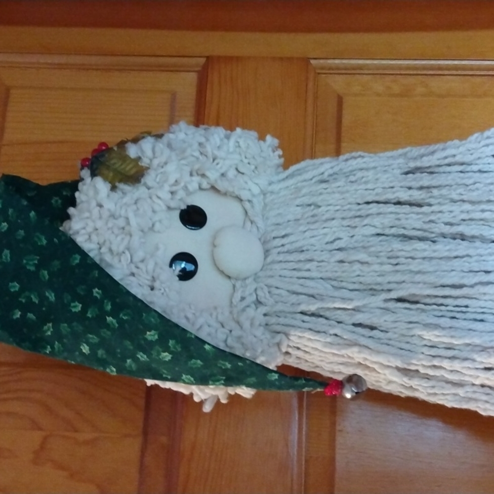 Christmas mop head with green holly hat big black eyes